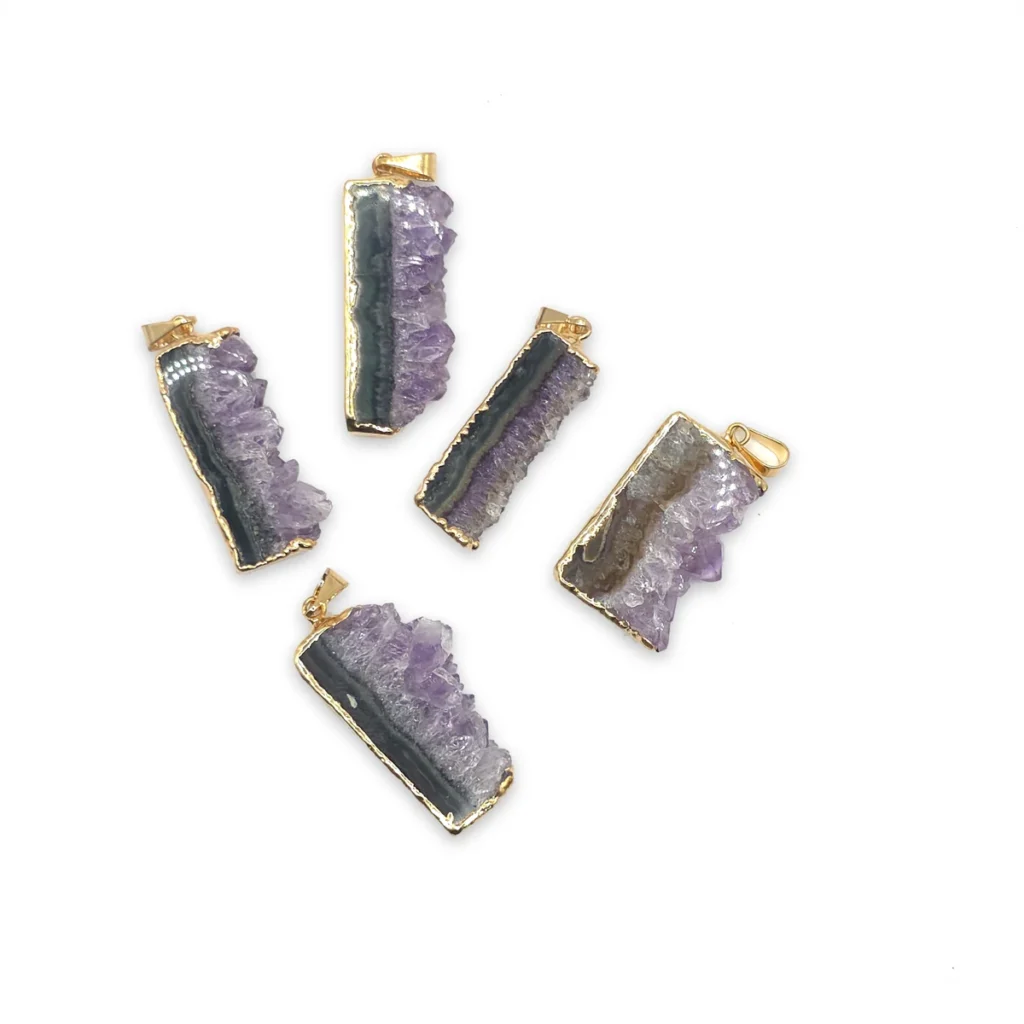Cinco láminas de amatista de borde dorado, cada una con una franja oscura junto a la fila de cristales violetas